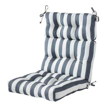 A charcoal gray striped lumbar pillow sits atop a wood and wicker accent  chair positioned at the corner of a white and gray…
