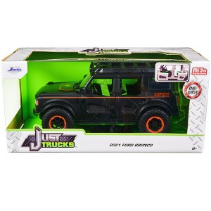 2021 Ford Bronco Matt Black with Orange Stripes and Roof Rack "Addictive Desert Designs" 1/24 Diecast Model Car by Jada - 1 of 3