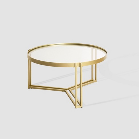 Round brass coffee table deals with glass top