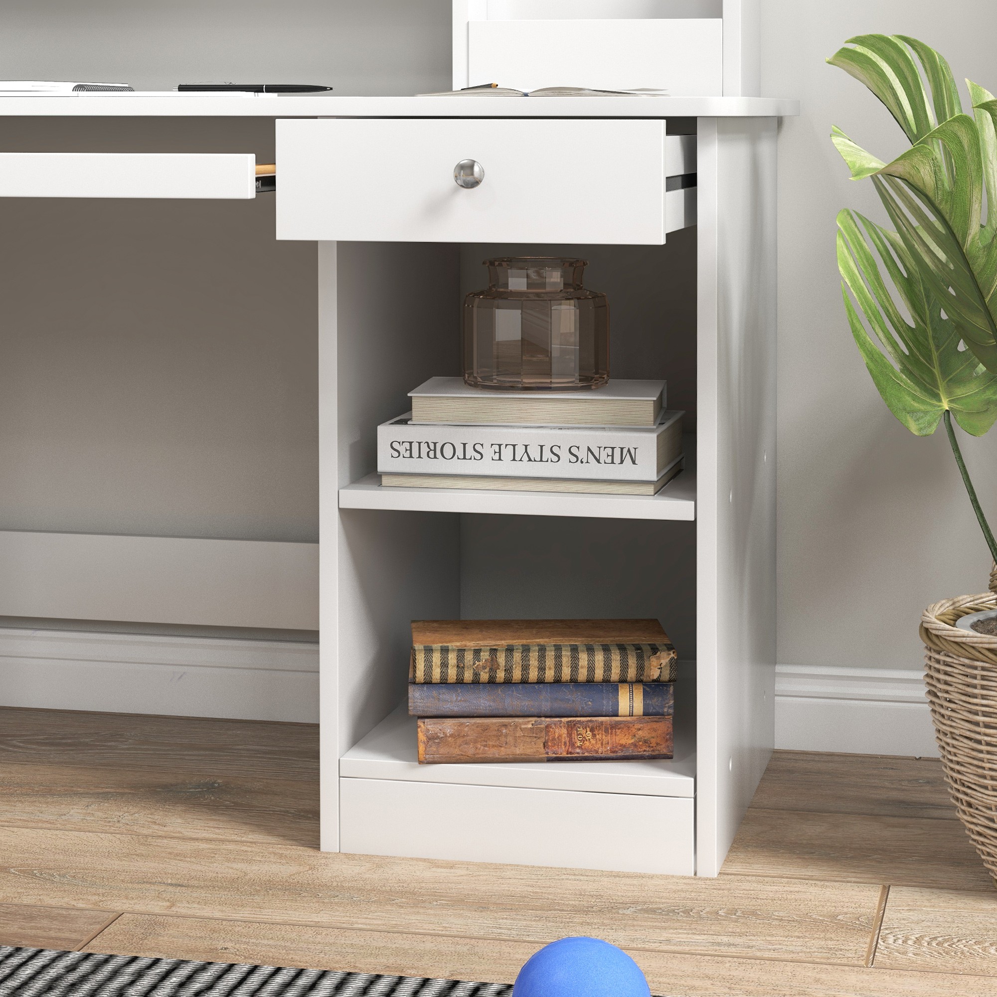 Close-up of the white desk with a drawer and open shelving storage.