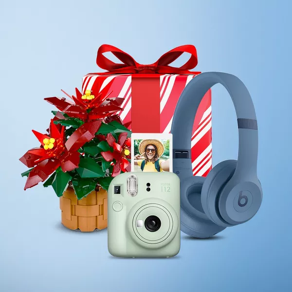 Man with a white stocking  and holding a present. Lego poinciana, 12 Days of skin care, Beats headphones and a instax camera