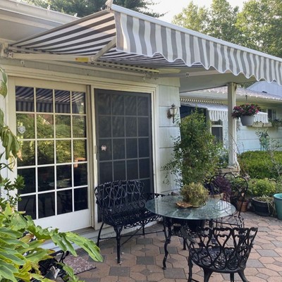 Grey and White Striped Retractable Patio Awning with White Frame