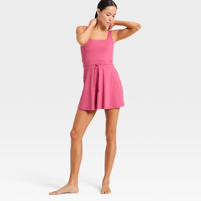 Pink colored sleeveless dress with a square neckline and a tie at the waist.