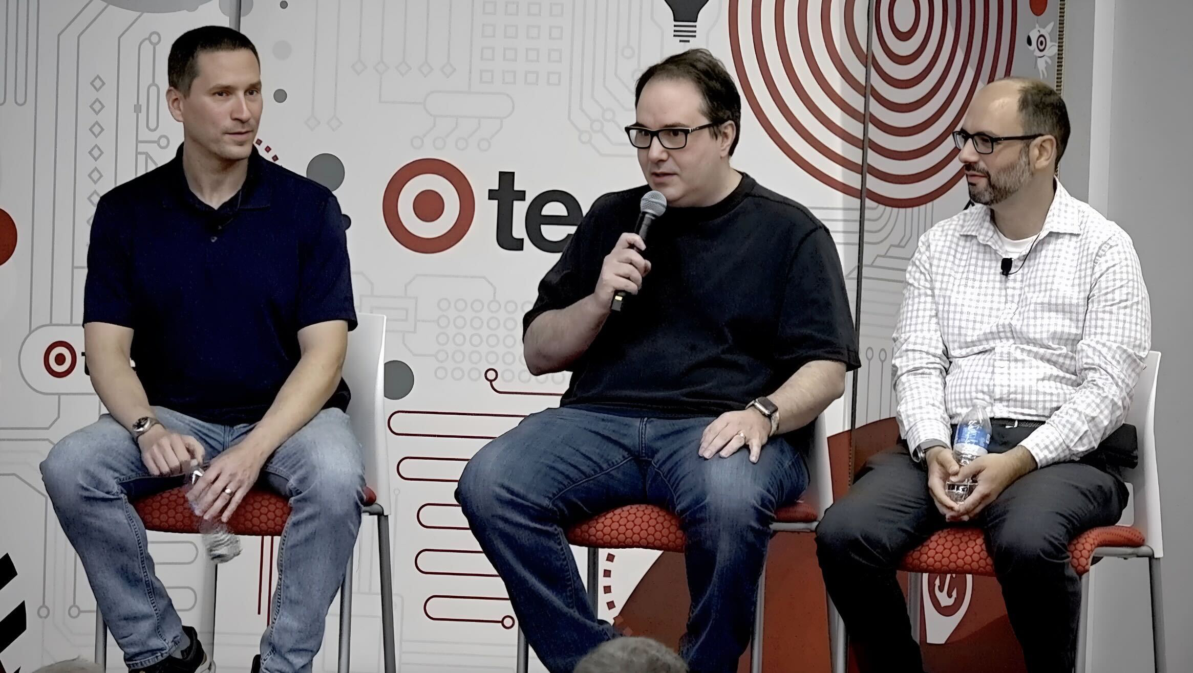 An image of three engineers having a panel discussion.