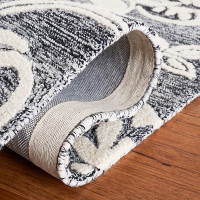 Handmade Black and Ivory Floral Wool Area Rug, 5' x 8'
