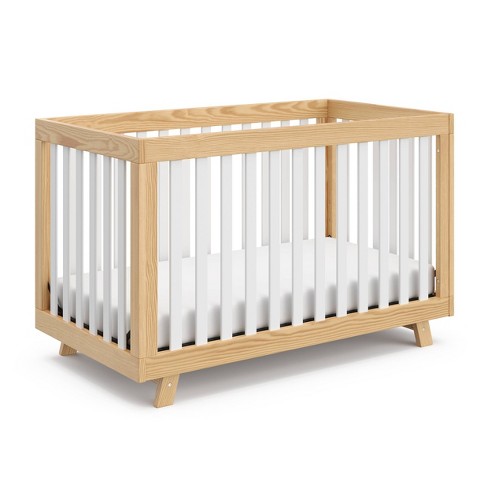 White crib outlet with natural wood