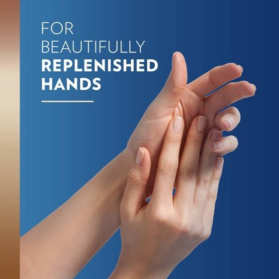 Text reads: "For Beautifully Replenished Hands." The image showcases a close-up of a woman's hands with a light skin tone gently touching, set against a gradient blue background. 