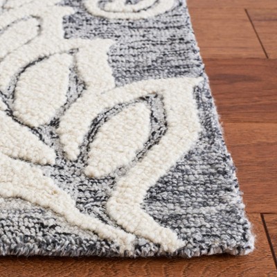 Handmade Black and Ivory Floral Wool Area Rug, 5' x 8'