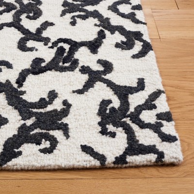 Handmade Black and Ivory Wool Floral 8' x 10' Rug