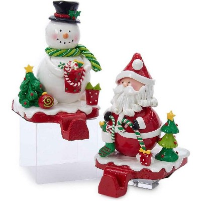 Set of 2 clay Santa Claus and snowman Christmas stocking hangers with glossy glaze finish.