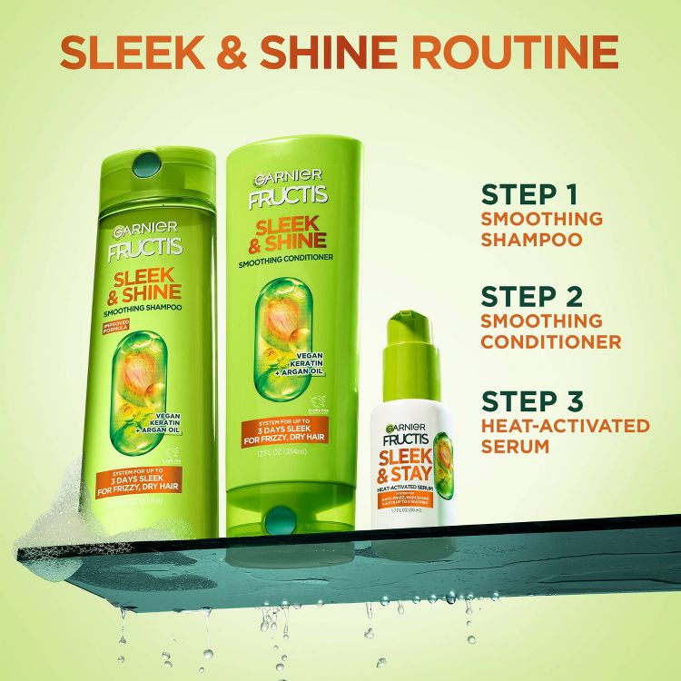 Green colored bottles of Garnier Fructis Sleek & Shine Smoothing Shampoo, Smoothing Conditioner, and Sleek & Stay Heat-Activated Serum with visible text detailing steps for a hair care routine.