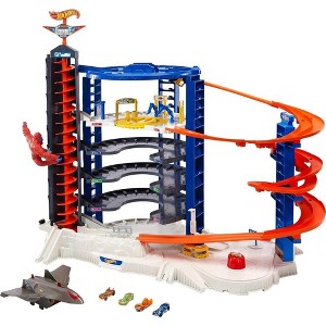 Hot Wheels Toy Car Track Set & 4 1:64 Scale Cars, Super Ultimate Garage, 3+ ft Tall Storage for 140 Cars - 1 of 4