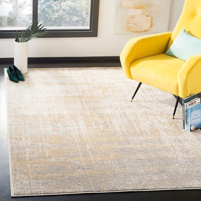 Creme and Gold Abstract Synthetic Area Rug 4' x 6'