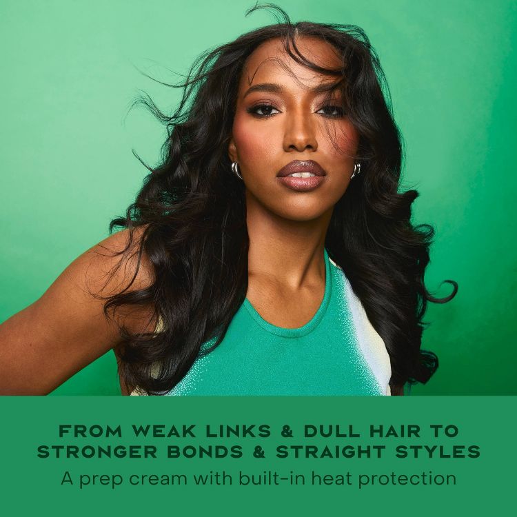 A person with long, wavy hair is shown against a green background, with text reading "From weak links & dull hair to stronger bonds & straight styles" and "A prep cream with built-in heat protection."