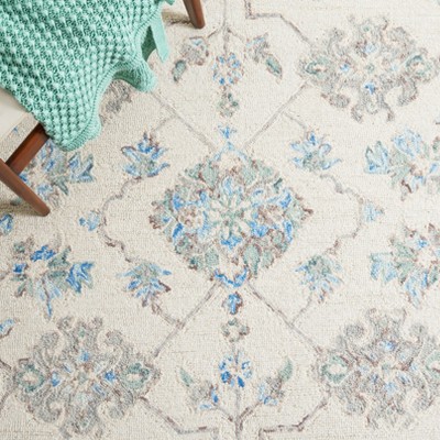 Elegant Ivory Wool 9' x 12' Hand-Tufted Rectangular Rug