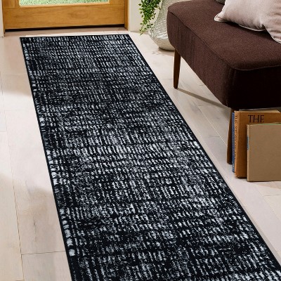 Black and Ivory Geometric Polypropylene Area Rug 2' x 7'