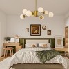 BAOURE 35" Gold Modern Chandelier with White Glass Globe Shades, Elegant Ceiling Light Fixture for Dining Room, Living Room, or Bedroom - 2 of 4