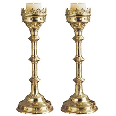 Lot - Large neo-gothic candlestick and a pair of candlesticks