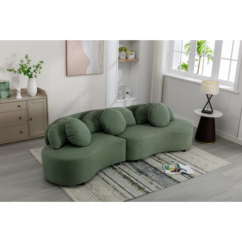 Beige 3 seater sectional couch with green and gray accent pillows