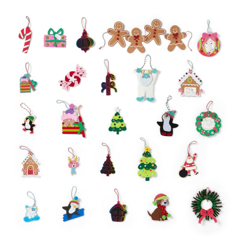 A collection of colorful Christmas-themed ornaments including gingerbread figures, candy canes, penguins, Christmas trees, and wreaths, each with a string for hanging.