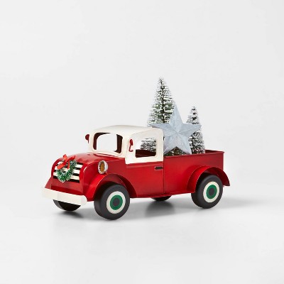 red metal truck with christmas tree