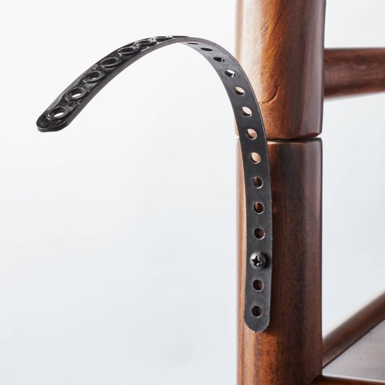 A dark brown colored wooden bookcase with a black metal bracket attached to its side.