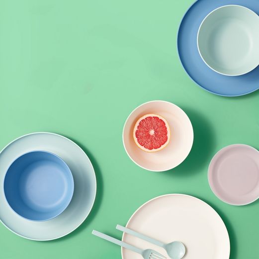 an arrangement of plates, bowls and utensils