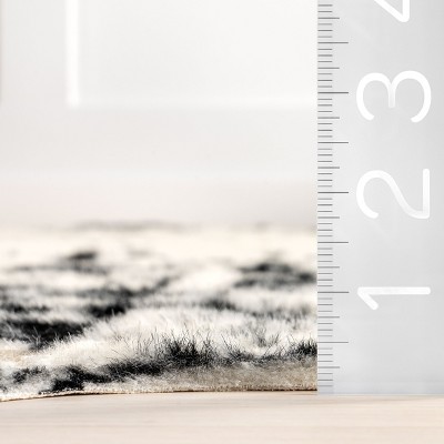 Black and White Tufted Synthetic Cowhide Accent Rug
