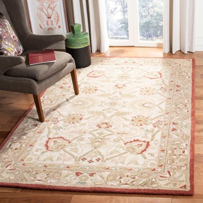 Handmade Beige and Rust Floral Wool Area Rug, 5' x 8'
