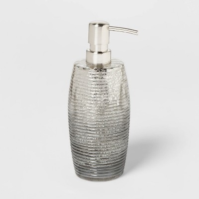 white and silver soap dispenser