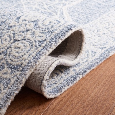 Blue and Ivory Tufted Wool 4' x 6' Abstract Area Rug