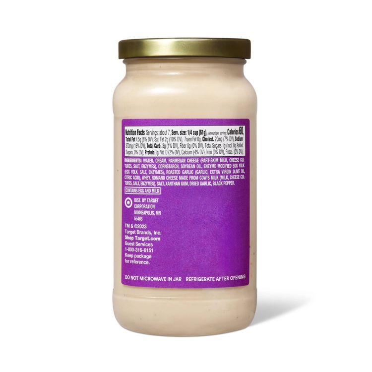 A jar of sauce with a gold colored lid and a purple label displaying nutrition facts and ingredients.