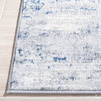 Blue and Ivory Abstract Synthetic Area Rug, 5'3" x 7'6"