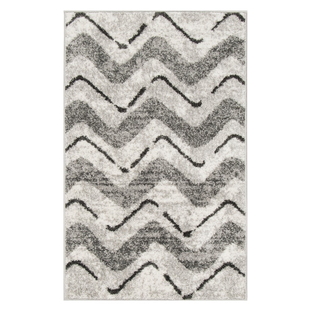 2'6 X4' Chevron Accent Rug Silver/Charcoal - Safavieh Inspired by global travel, the bold colorful motifs and alluring patterns, Briarwood Adirondack Area Rugs translate rustic lodge style into supremely chic, easy-care floor coverings. Made using enhanced polypropylene yarns, Briarwood rugs explore stylish over-dye and antiqued looks, making a striking fashion statement in any room. Safavieh translates rustic lodge style into the supremely chic and easy-care collection. The Briarwood Collection is power loomed using soft yet durable enhanced polypropylene yarns for a comforting feel underfoot and lasting beauty.   Size: 2'6 X4'. Color: One Color. Pattern: Chevron.