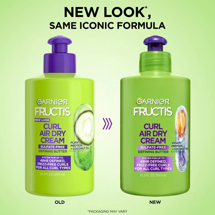 Two green colored bottles of Garnier Fructis Curl Air Dry Cream, one labeled "Old" with plant protein and coconut oil, and the other labeled "New" with vegan protein and coconut oil, both 10.2 fl oz (300 ml).