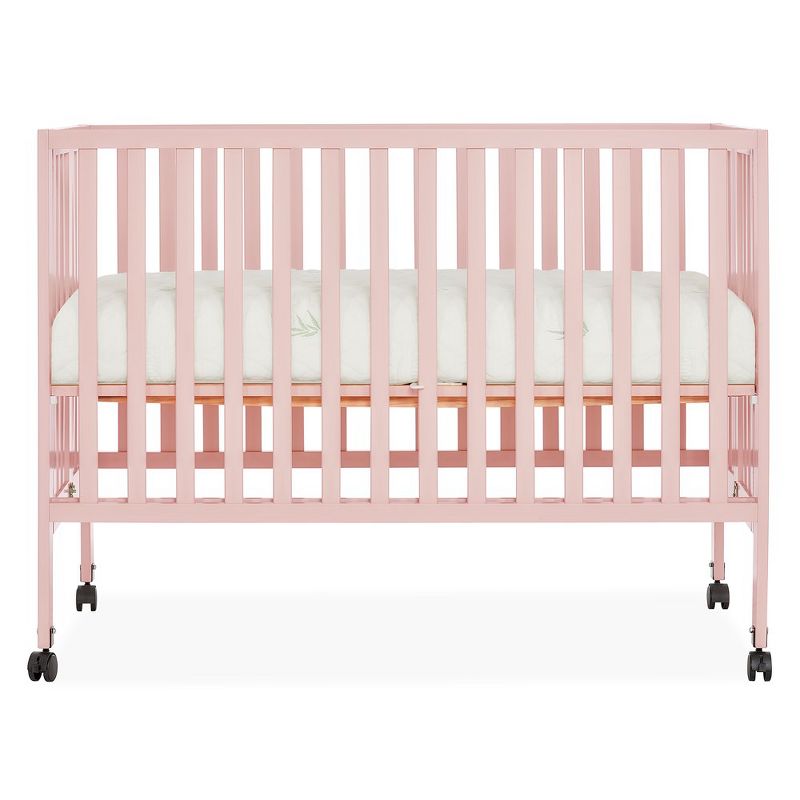 Dream On Me Quinn Full-Size Folding Crib I Removable Wheels I Modern Nursey I Adjustable Mattress Support I Patent Folding System in Blush Pink, 1 of 11