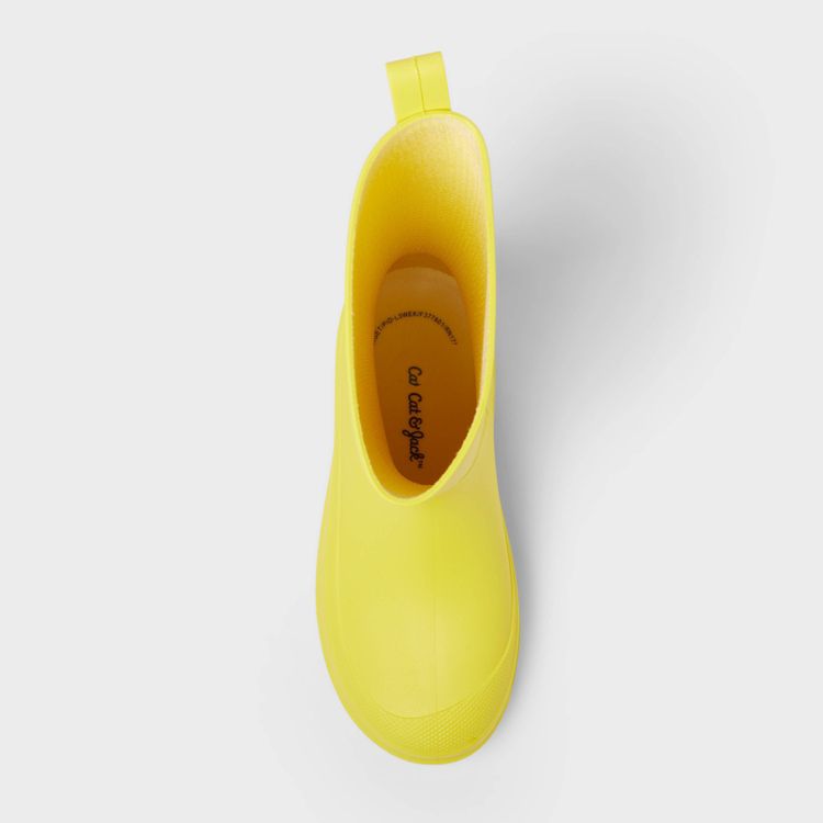 A single yellow colored boot with a pull tab, viewed from above, showing the interior and insole with text.