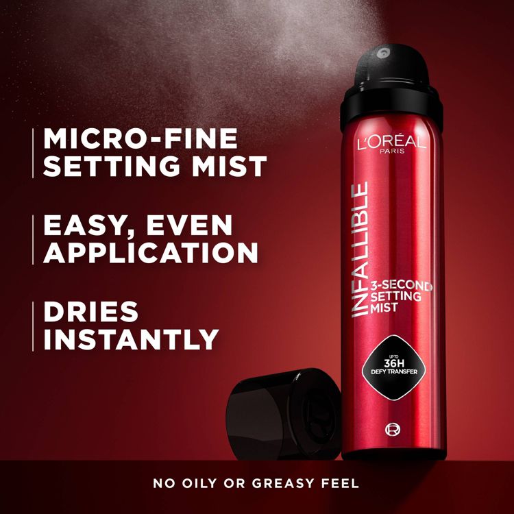 Red colored spray can labeled "L'Oreal Paris Infallible 3-Second Setting Mist" with text highlighting "Micro-Fine Setting Mist," "Easy, Even Application," "Dries Instantly," and "No Oily or Greasy Feel."