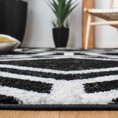 Black and Ivory Geometric 4' x 6' Synthetic Area Rug