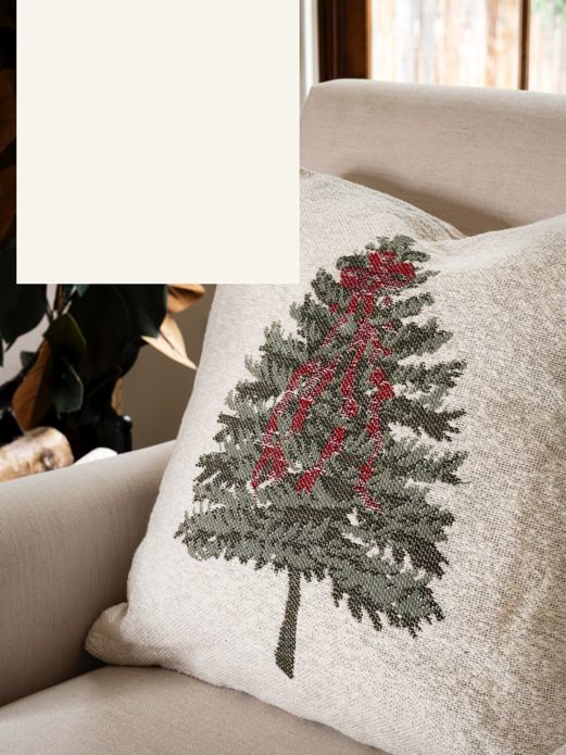 Holiday pine tree throw pillow on chair.