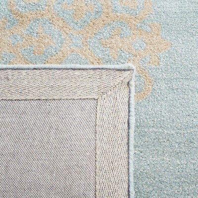 Ivory and Turquoise Round Tufted Wool Area Rug