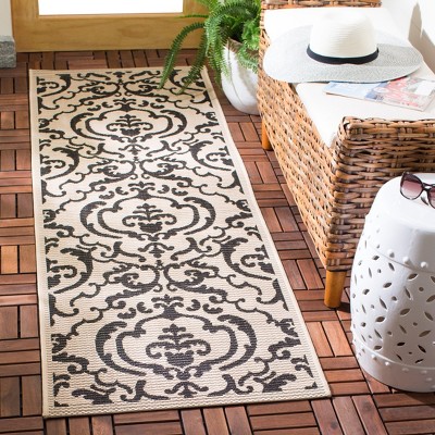 Sand and Black Floral Motif Synthetic Runner Rug