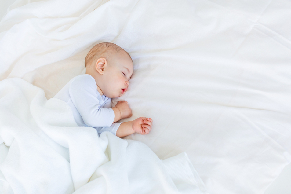 Sleeping Baby In A Light Blue Onesie