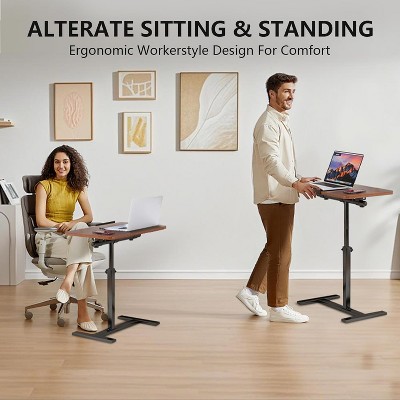 Two people using adjustable tables in a living space.