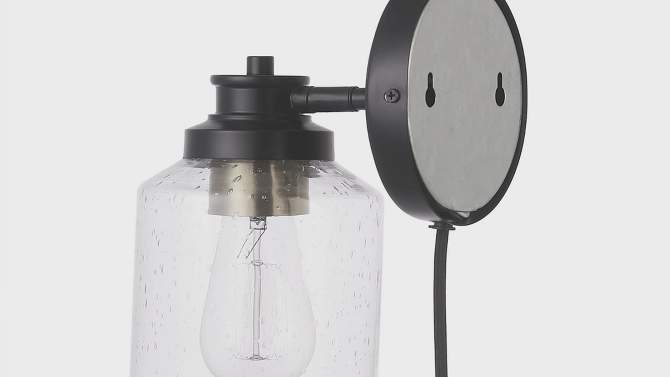 Willow 1-Light Matte Black Plug-In or Hardwire Wall Sconce with Seeded Glass Shade - Globe Electric, 2 of 8, play video
