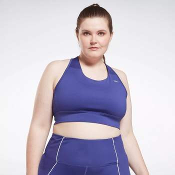 A woman in a sports bra top and tight pants running Image & Design ID  0000513066 