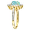 EVERLY JEWELRY | Yellow Silver 2 1/6 ct TGW Oval Shape Blue Ethiopian Opal and White Topaz and 1/10ct TDW Diamond Halo Ring - 2 of 4