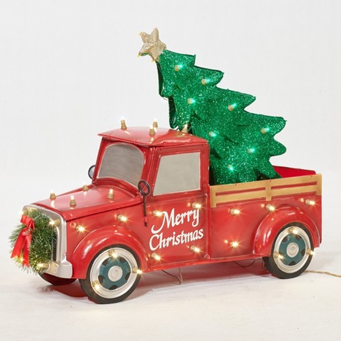 red truck with lighted christmas tree