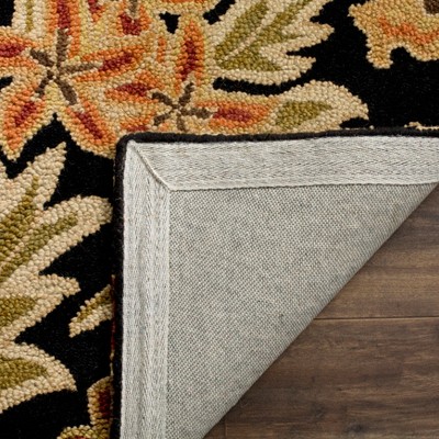 Handmade Black and Multicolor Floral Wool Rug, 2' x 3'