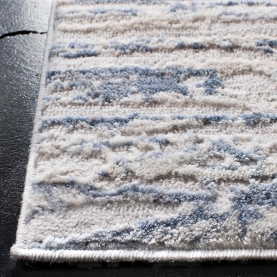 Ivory and Blue Abstract 6&#039; x 9&#039; Stain-Resistant Synthetic Rug